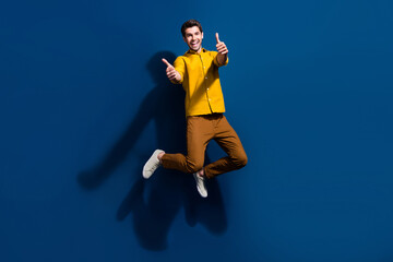 Aufkleber - Full size photo of handsome young man jump show thumb up good quality wear trendy yellow outfit isolated on dark blue color background