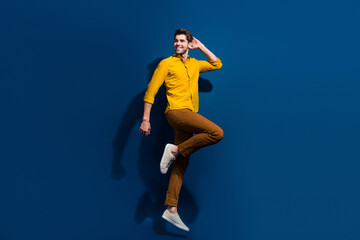 Aufkleber - Full body photo of handsome young guy jumping dance discotheque wear trendy yellow outfit isolated on dark blue color background
