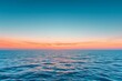Serene sunset sky with blue and orange hues over calm ocean horizon - Panoramic landscape