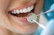 A woman is smiling and has her teeth cleaned by a dentist