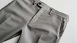 A light grey pair of formal trousers for men presented against a white background