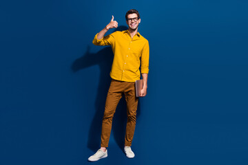 Poster - Full size photo of handsome young man show thumb up it specialist wear trendy yellow outfit isolated on dark blue color background