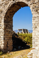 Wall Mural - Ruins of ancient Miletus. Through a stone arch, the ruins of Miletus reveal the remnants of a grand past. Vertical. Milet (Aydin), Turkey (Turkiye)