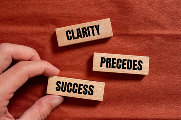 Clarity precedes success words written on wooden blocks with brown background. Conceptual business symbol. Copy space.