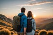 Rear view of young couple on a hiking trip at sunset