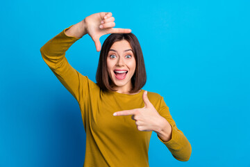 Canvas Print - Photo of excited cheerful lady dressed shirt showing fingers photo gesture empty space isolated blue color background