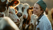 A smiling veterinarian with a stethoscope stands in front of cows in a field at sunset.