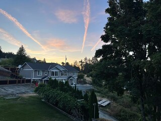 two houses are next to each other, with some clouds in the sky