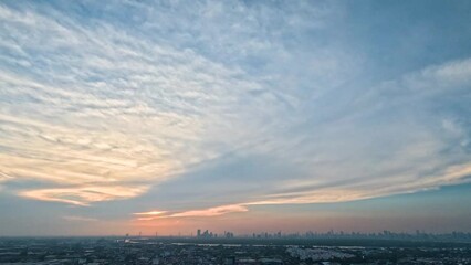 Wall Mural - Sunset and cirrus clouds from thunderstorms over the city and river time lapse majestic sunset landscape.