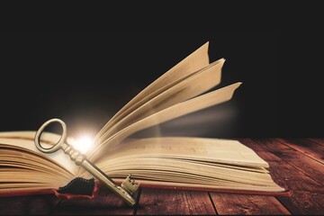 Poster - image of open book with vintage key on wooden table