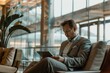 Businessman Using Tablet in Airport Lounge, Travel and Technology Concept
