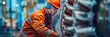 © Wolfilser - a mechanical engineer works on a huge metal machine