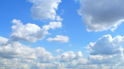 Wall Mural - Blue sky covered with slowly moving white clouds.