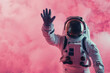 A space traveler in a detailed astronaut suit extends a hand on a vivid pink background, suggesting communication