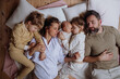 © Halfpoint - Top view of family sleeping in bed with kids and newborn baby. Perfect moment. Strong family, bonding and parents' unconditional love for their children.