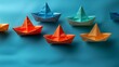 colorful origami ships on blue background