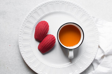 Sticker - Red velvet madeleines on a white plate, red madeleines cake or cookies on a white background