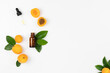 Natural Cosmetic Apricot Oil. Dropper lid with pipette and bottle on white background with fresh peach fruits and leaves. Top view, layout, place for text.