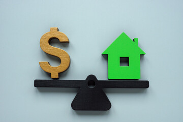 Wall Mural - Scales with house and dollar sign. How much is my property worth concept.