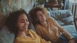 Joyful Friends Relaxing on Sofa: Positive Conversation at Home