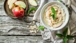 Tasty healthy food oatmeal porridge on bowl with apple slices and mint on wooden table. AI generated