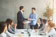 © Prostock-studio - Two businessmen shaking hands at meeting in modern office