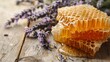Close-up of honey in honeycombs and lavender on a rustic wooden table, natural ingredients