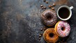 Assorted donuts with coffee on a dark rustic background sprinkled with powdered sugar. Breakfast concept