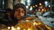 Man lying on street covered in blankets
