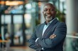 © Lucija - Successful mature black businessman portrait, corporate office setting