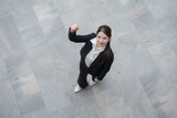 Fototapeta Natura - Confident businesswoman giving thumbs down
