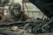 An auto mechanic engrossed in troubleshooting under the hood of a car