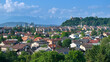 AERIAL: A panoramic cityscape of Ljubljana against the scenic alpine backdrop.