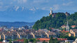 AERIAL: Historic Ljubljana castle overlooks the downtown beneath the mountains.