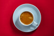 Top view a white cup of black coffee on red background at morning for breakfast, closeup