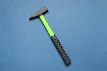 Poster - New hammer with rubber handle on blue background, top view