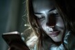 A woman looking at her cell phone in a dimly lit room. Perfect for illustrating technology use at night