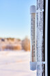 16 degrees below zero Celsius on an outdoor thermometer mounted on wooden window frame.