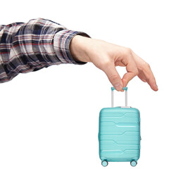 Wall Mural - luggage and hand luggage, a miniature mint-colored suitcase on a white isolated background in the hand, the concept of a limit on the weight of baggage carried in airlines