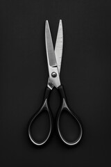 Poster - A pair of scissors placed on a table. Suitable for office or school related designs