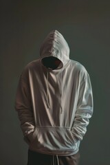Wall Mural - A man wearing a white hoodie with hands in pockets. Suitable for fashion or urban lifestyle themes