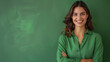 © kosoff - Happy young smiling confident business woman wearing green shirt, on a green background standing arms crossed looking at camera,