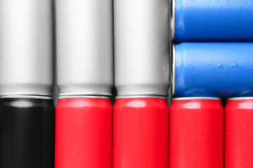 Canvas Print - Energy drinks in wet cans as background, top view