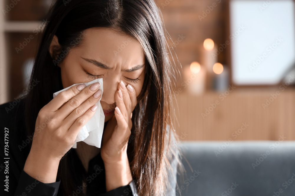 Grieving young Asian woman crying at funeral, closeup