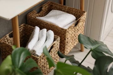 Wall Mural - Storage baskets with folded white towels indoors