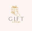 Hand holding gift box with lettering gift shop drawing in linear style on beige background