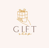 Fototapeta  - Hand holding gift box with lettering gift shop drawing in linear style on beige background