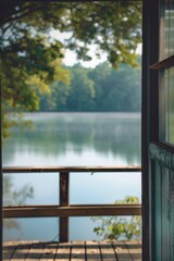 Poster - A serene view of a lake through an open door. Perfect for travel and nature concepts