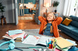 © HBS - Completed homework. Relaxed little girl in home clothes leaning on back of chair by desk with closed eyes
