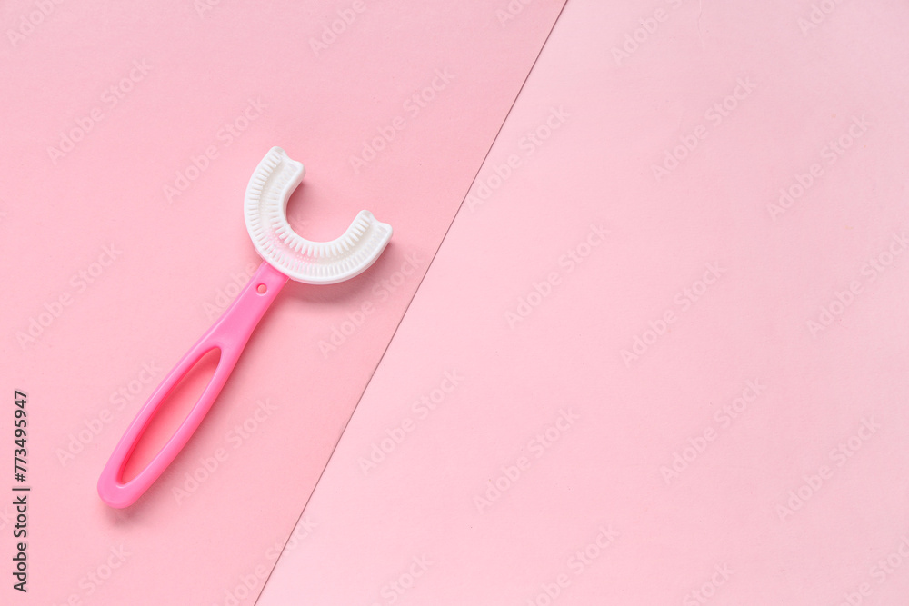Children's toothbrush on pink background